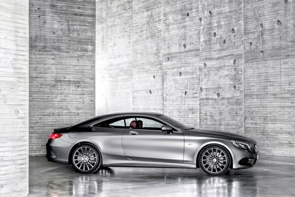 Silver Mercedes Benz on a gray background