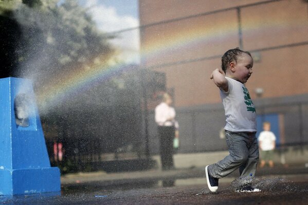 The child rejoices in the drops of water