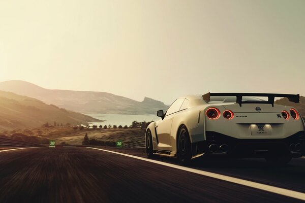 White nissan driving on the highway at speed against the background of mountains