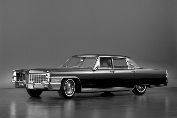 Black Cadillac Fleetwood on a gray background