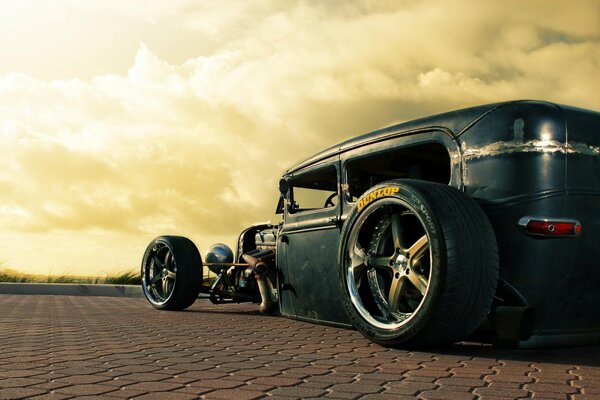 An old Ford Rusty car. against the sky