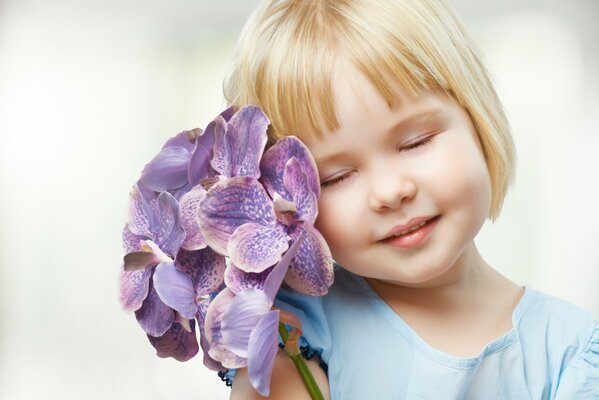 Little girl with flowers on a white background