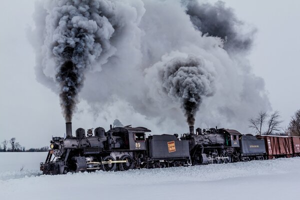 Black smoke from the train pipes in winter