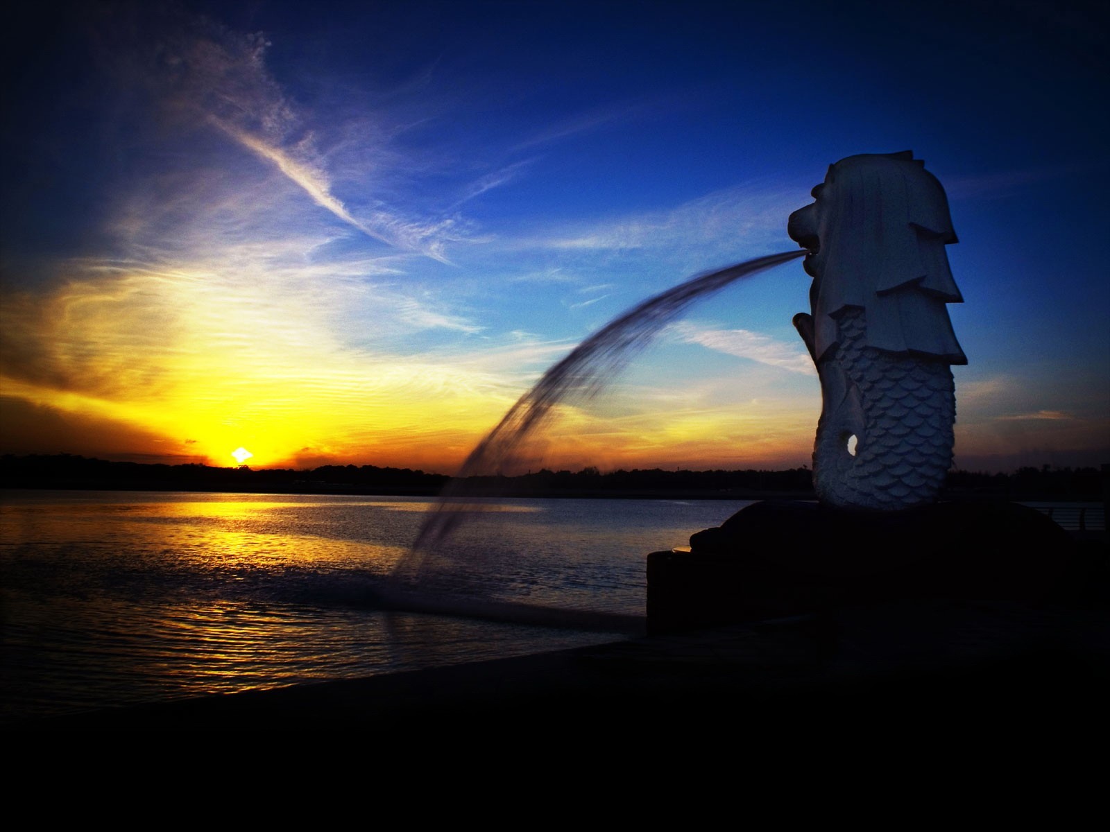 zachód słońca fontanna singapur statua merlion