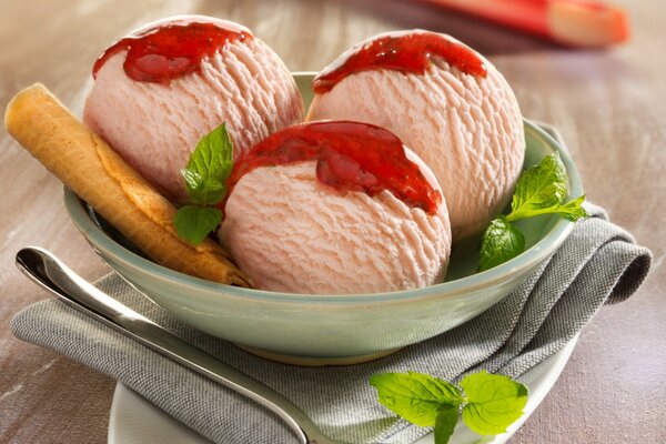 Ice cream balls with jam and a waffle tube