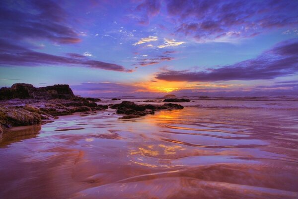 Sunrise. Clouds hover over the shore