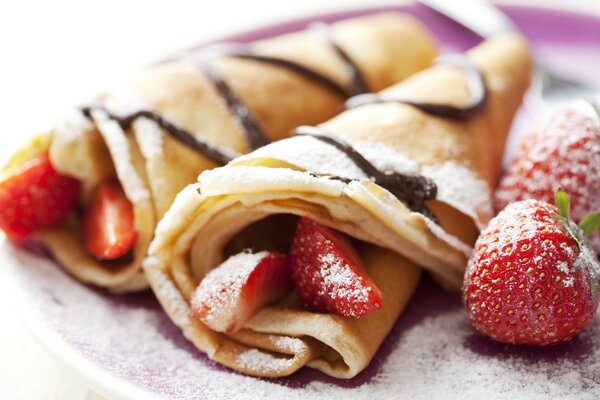 Pancake with strawberries in chocolate