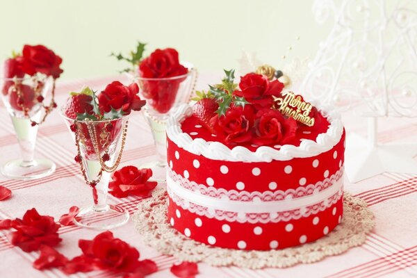 Red cake with white polka dots and glasses with strawberries and flowers