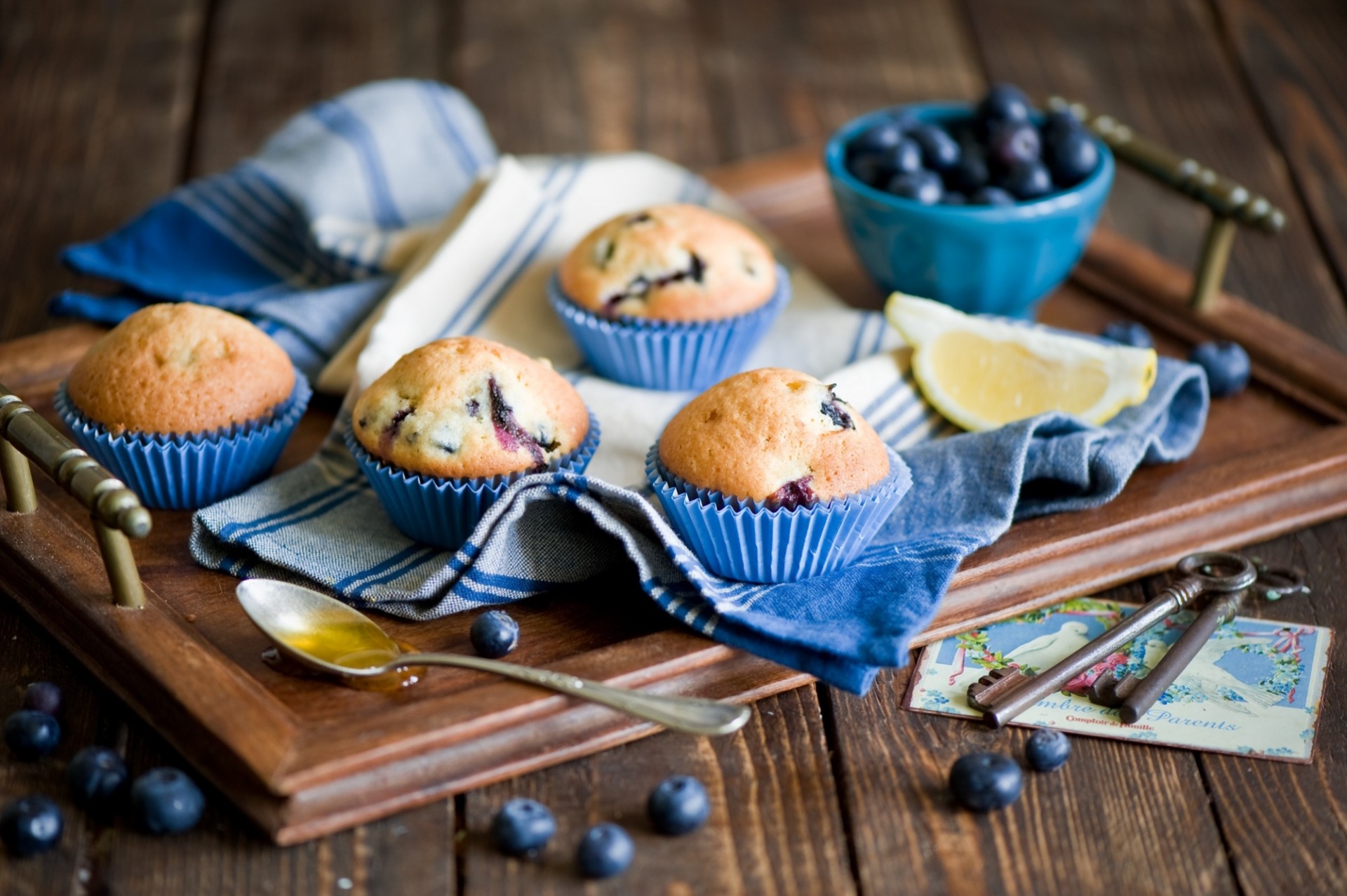 tray cupcakes blueberries bed berries spoon keys towel