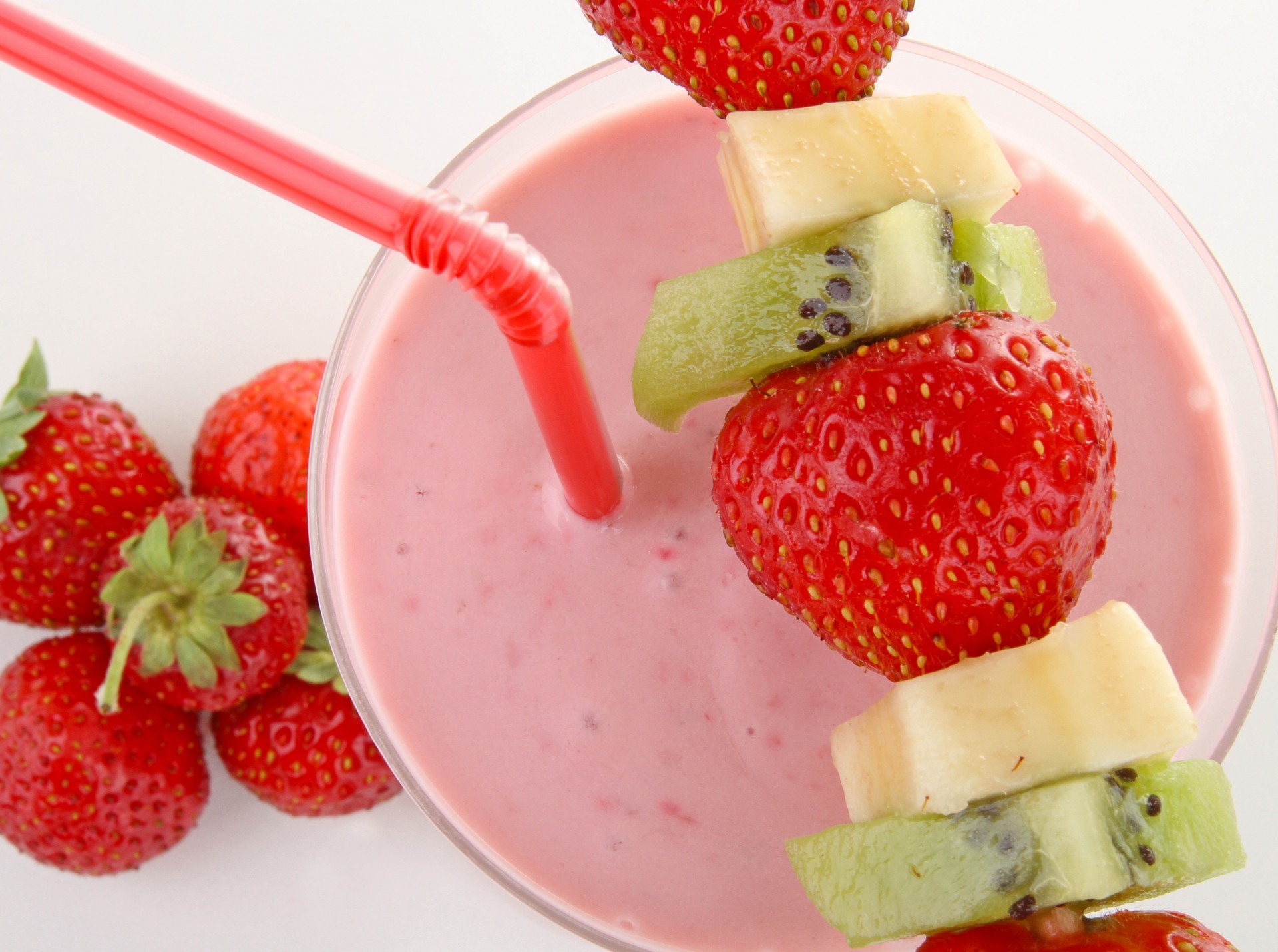 trawberry berries straw glass white background yogurt