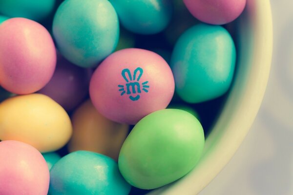 Oeufs de Pâques multicolores dans une assiette blanche