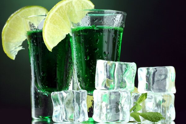 Alcohol with lime and ice cubes