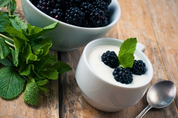 Dessert on a beautiful background, yogurt with blackberries