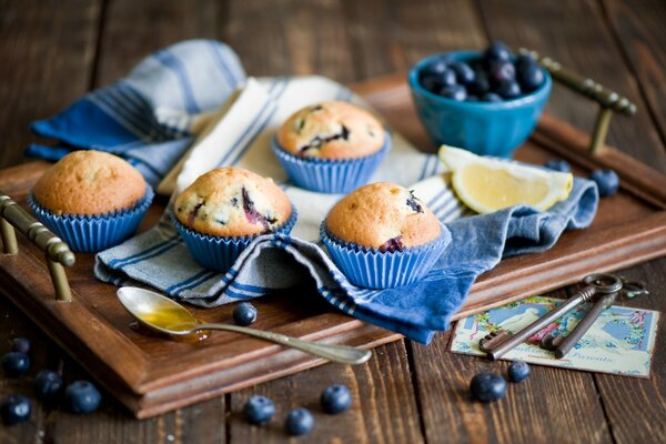 Tray with beautiful cupcakes, blueberry pastries