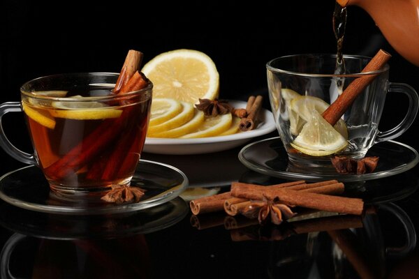 Mugs of tea with cinnamon and lemon