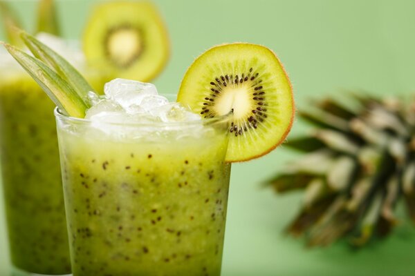 A glass with a cocktail of kiwi and ice