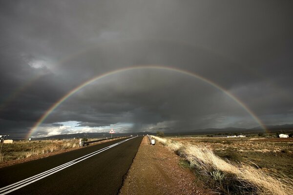 Rainbow over the highway under the clouds