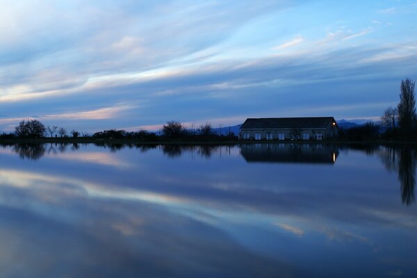 Lake in the evening. The building in the reflection of the reservoir