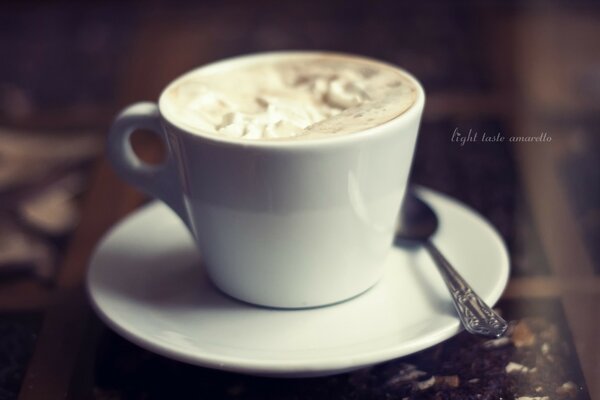 Cappuccino in a white cup on the table