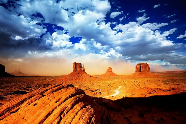 White clouds in the desert with rocks