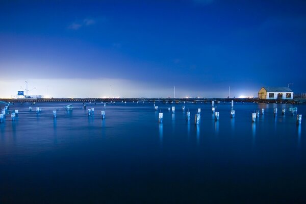 Blue sea water. Pillars in the water