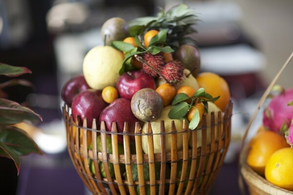 Basket with exotic fruits on the table