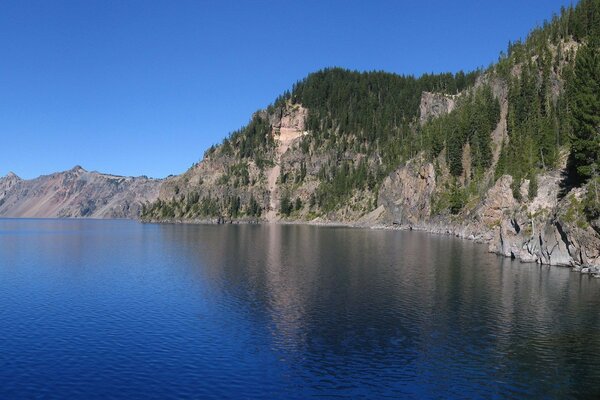 A beautiful lake with wooded rocks on the shores