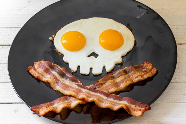 Skull-shaped fried eggs with bacon