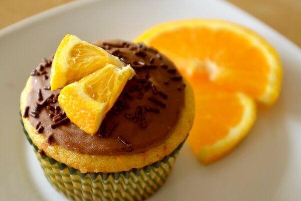 Sweet cupcake in icing with orange