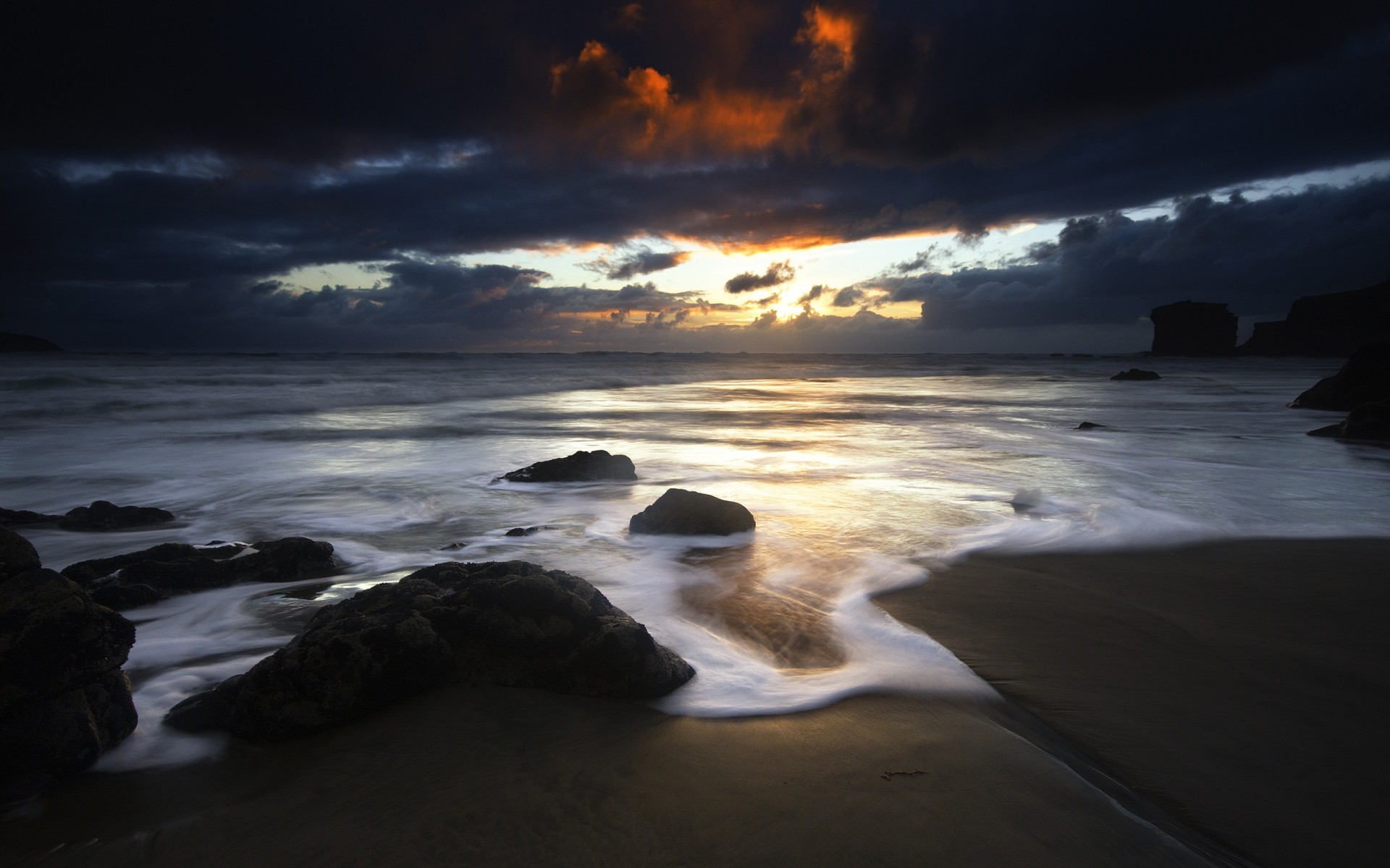 beach stones clouds sunset