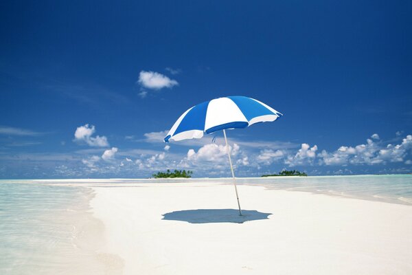 Umbrella on the ocean on the background of the sky