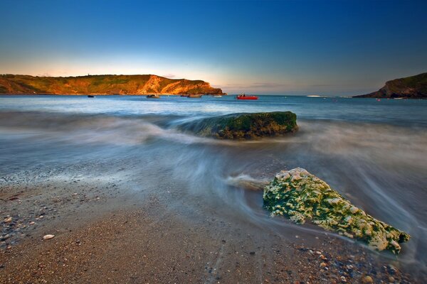 Las olas golpean las rocas y ruedan hacia la playa