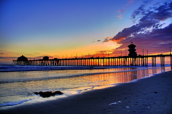 Sunset on the pier. View from the shore