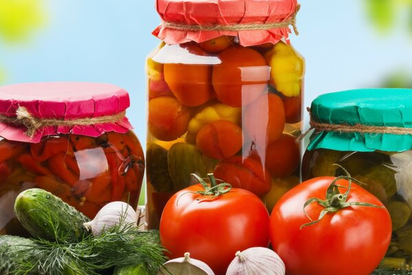 Fresh vegetables and jars of pickles