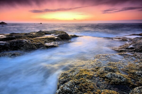 Sunset over the rocky seashore