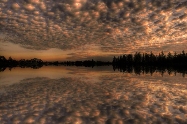 Orange sky and its reflection in the lake