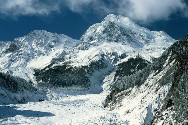 Mountain landscape. Snow-capped mountains against a blue sky