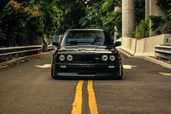 BMW e30 black on the road in front