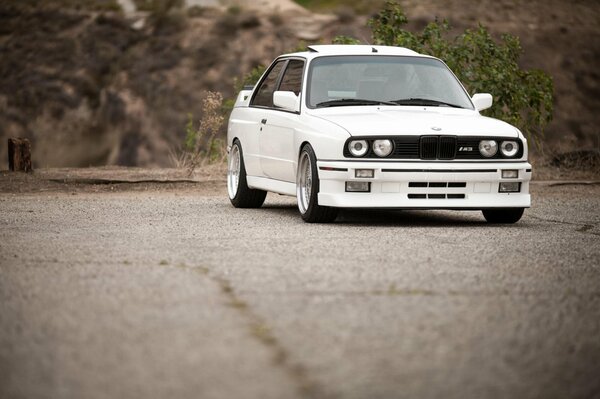 White tuning BMW on the roadbed