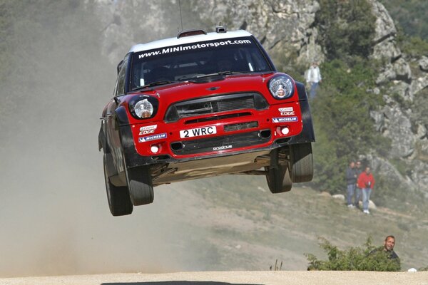 Red mini John Cooper works in the air above the ground