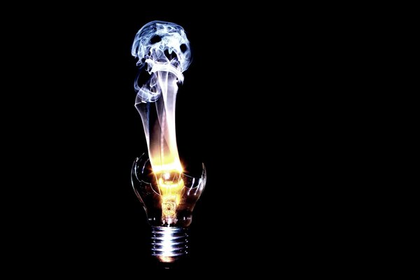 Smoke in the form of a skull from a cracked light bulb