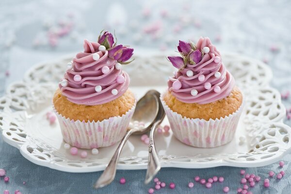 Cupcakes with cream and spoons