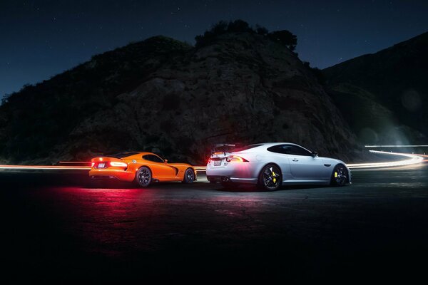 Auto wallpaper Dodge and Jaguar on the night road.