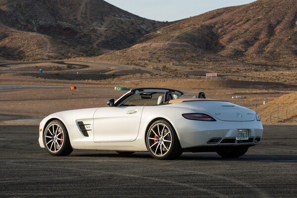 White, luxury car on the background of mountains