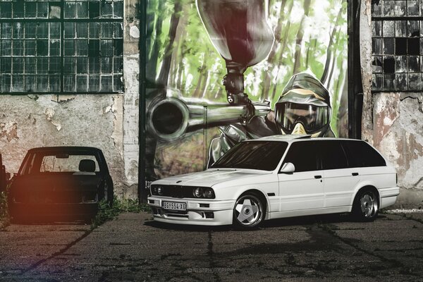 White BMW station wagon on a graffiti background