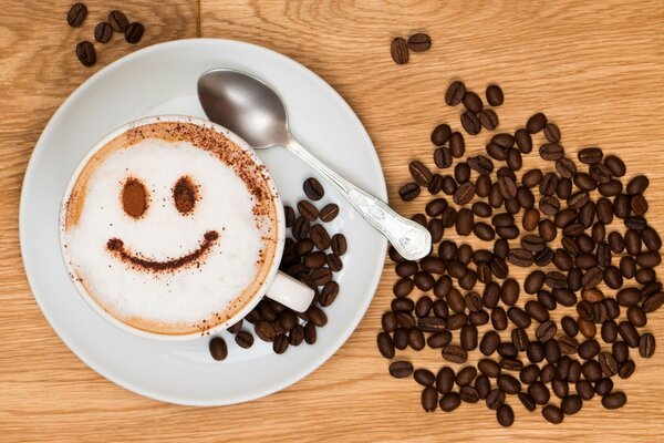 A scattering of coffee beans at the cappuccino cup