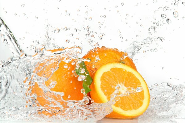 Fresh bright citrus fruits under running water