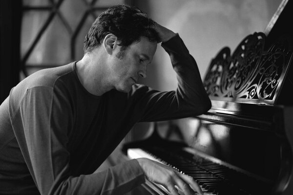 Actor Colin Firth plays the piano