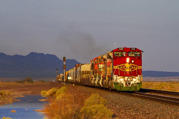 Red diesel locomotive on the background of the autumn landscape