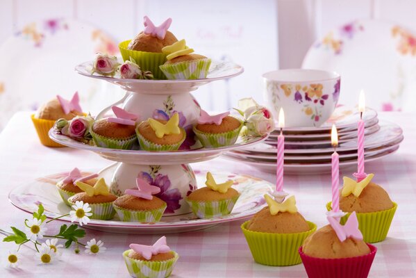 Table with desserts. Cupcakes with candles